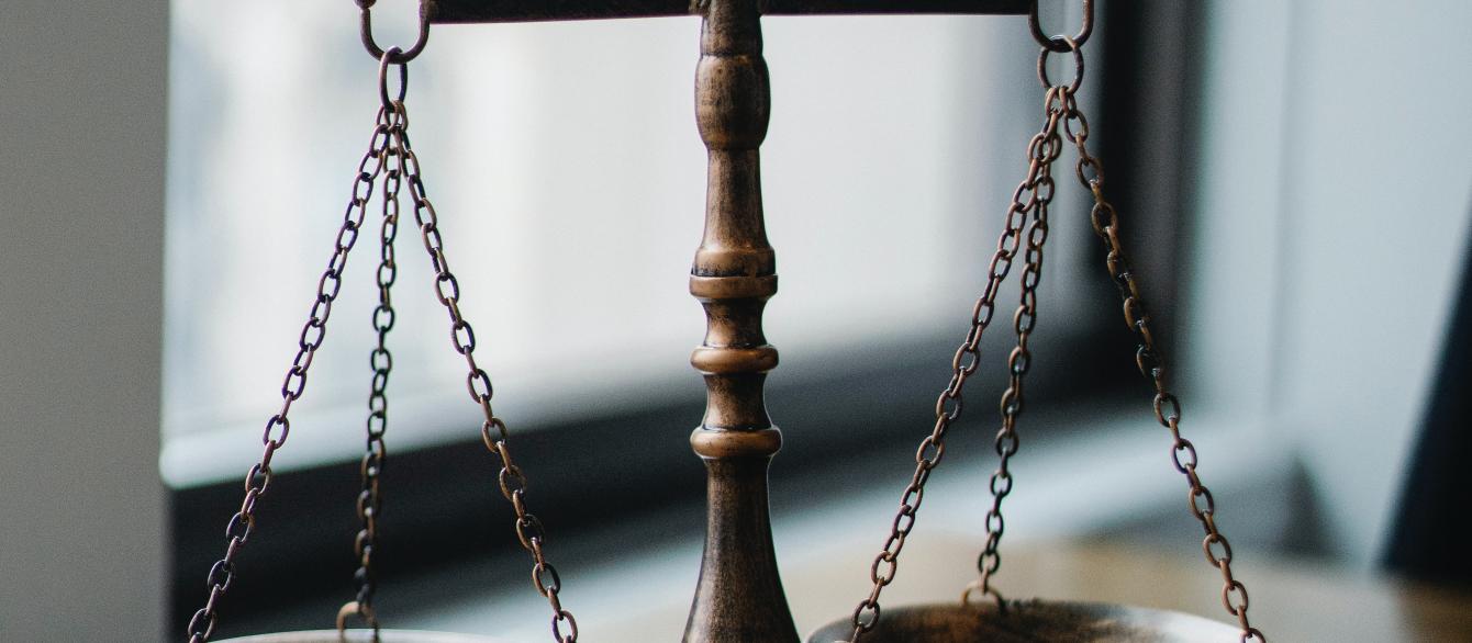 justice scales and gavel on tabletop