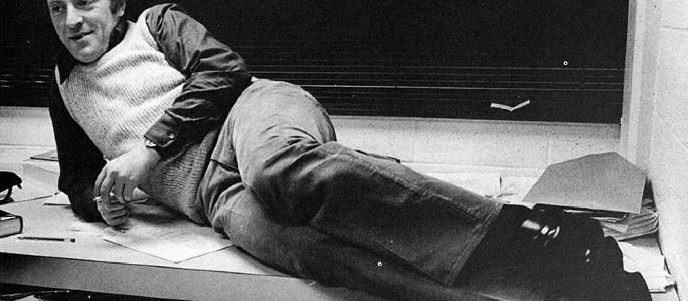 Josef Brodsky reclining in front of a blackboard