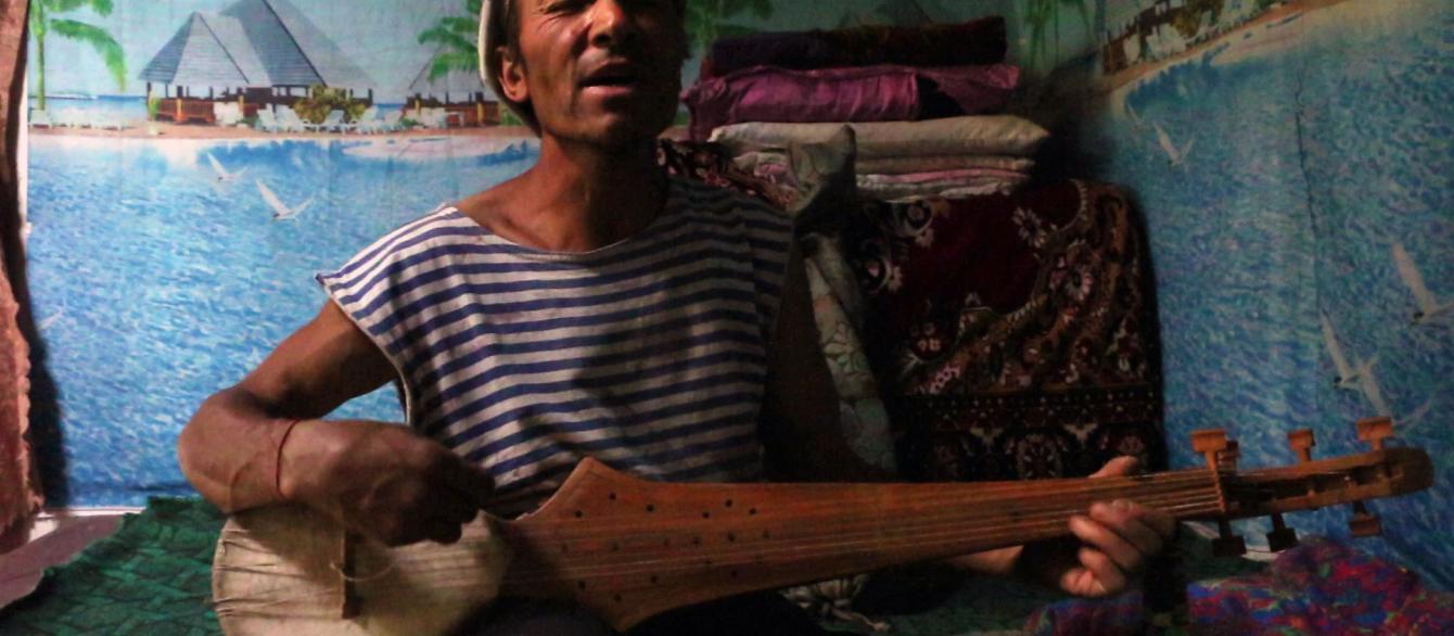 a man singing with mandolin