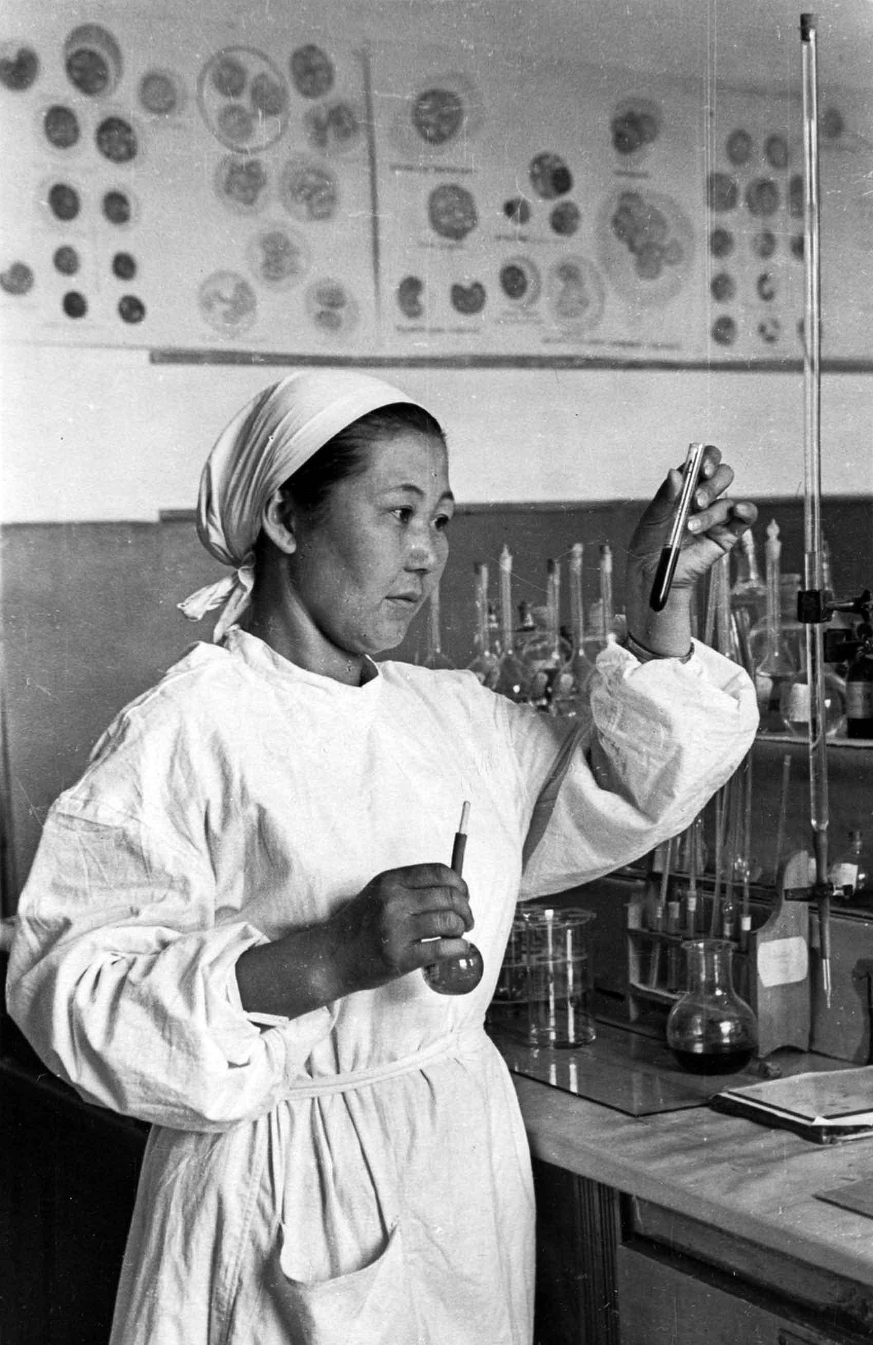 Researcher in laboratory holding test tubes