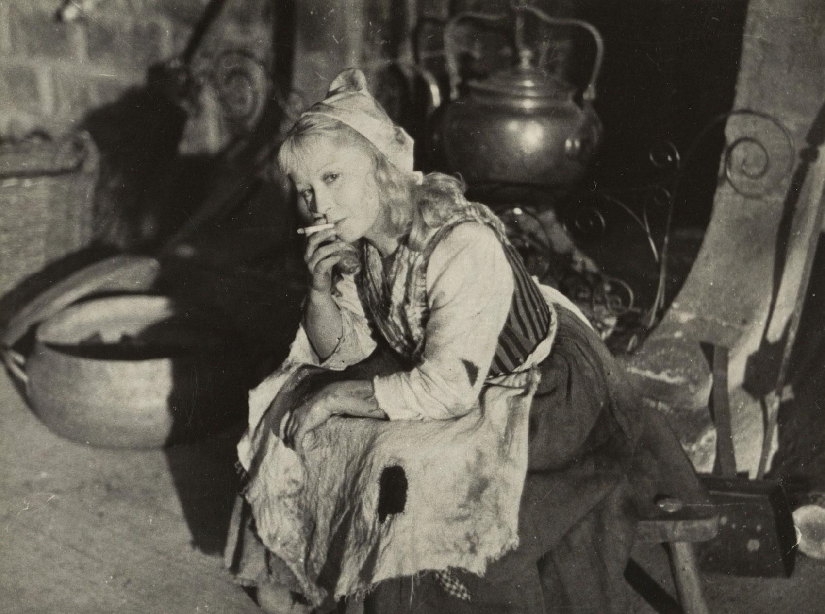 Actress Ianina Zheimo sits and smokes on the set of the movie "Cinderella."
