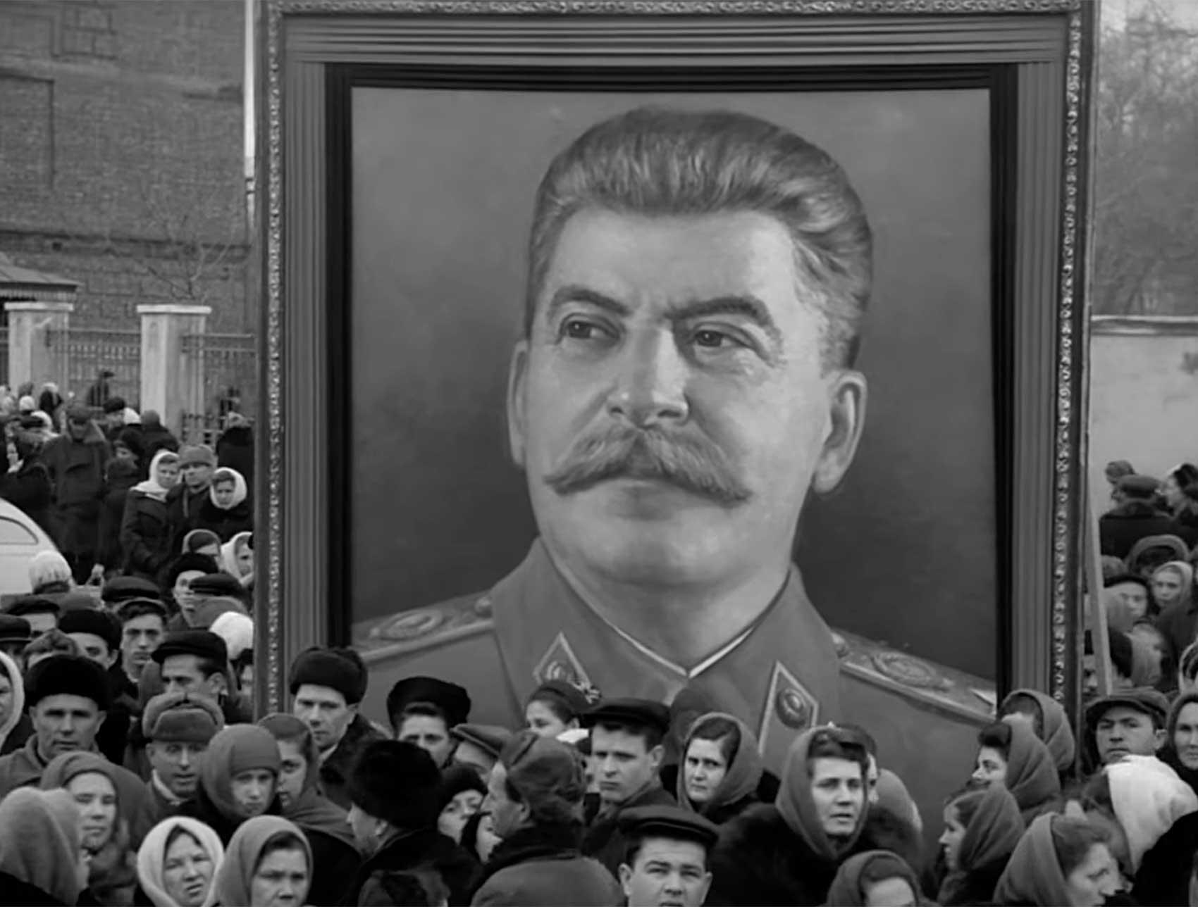 Large portrait of Stalin carried by crowds