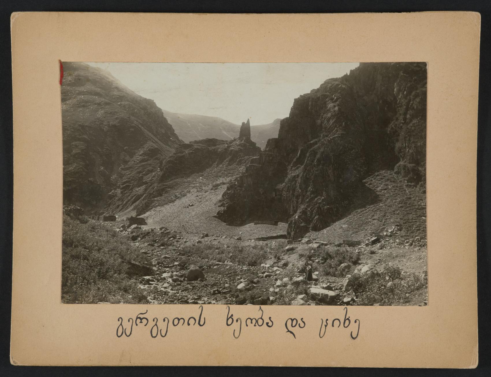 Sepia photo of Gergeti Gorge and tower