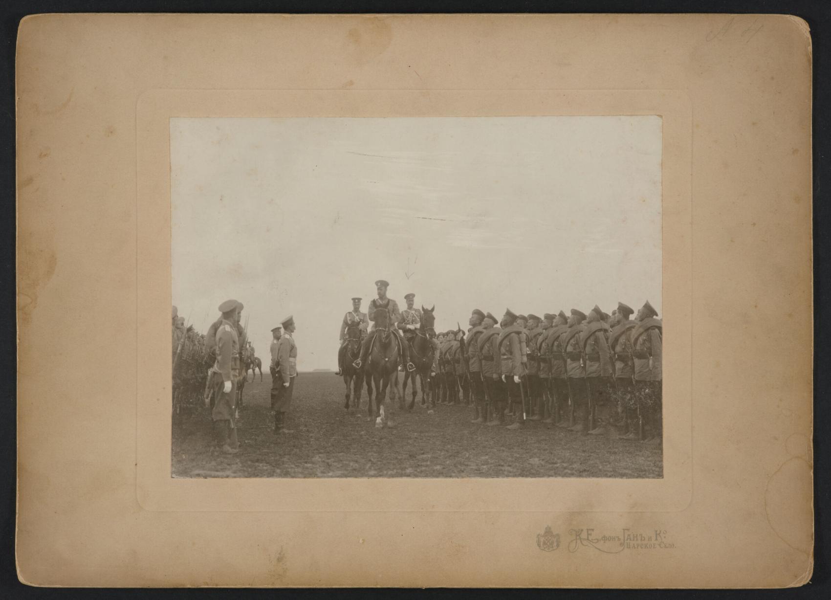 Military leader on a horse inspecting troops