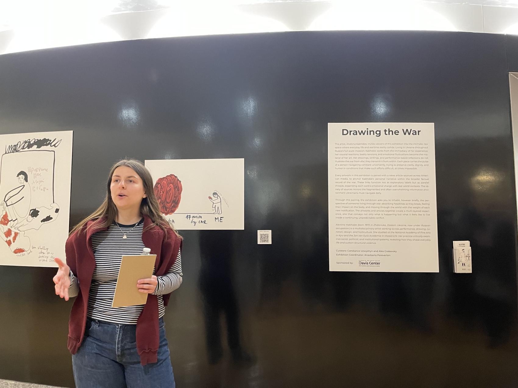 Anastasiia Pereverten speaking at an exhibition she helped organize.