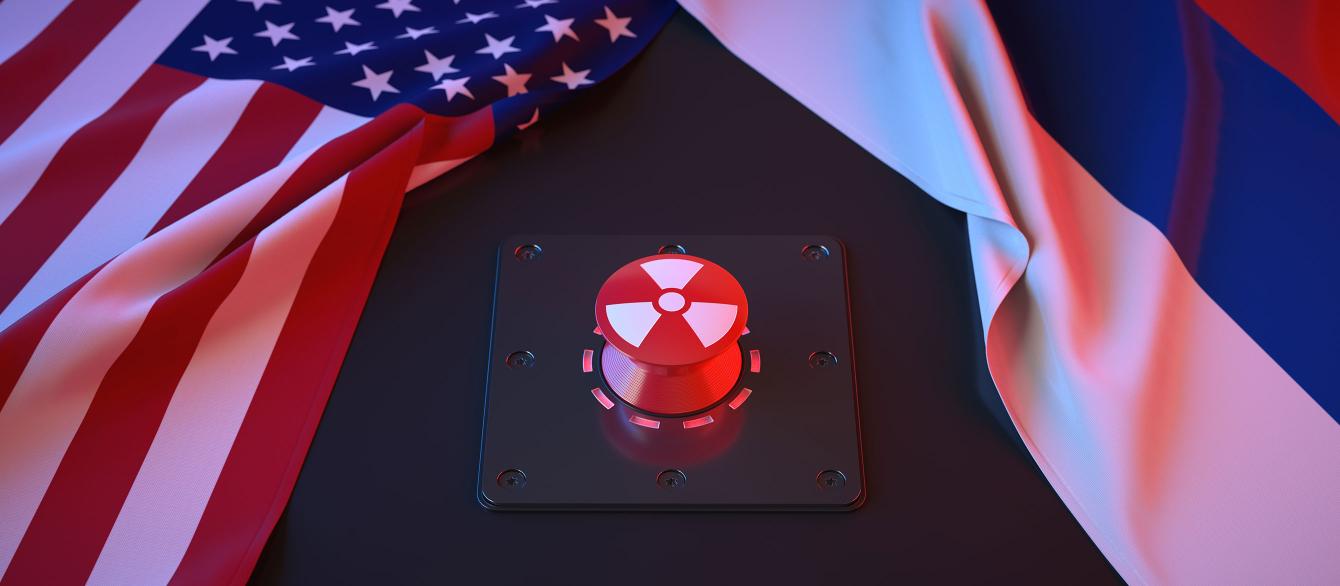 Red button in between U.S. and Russian flags