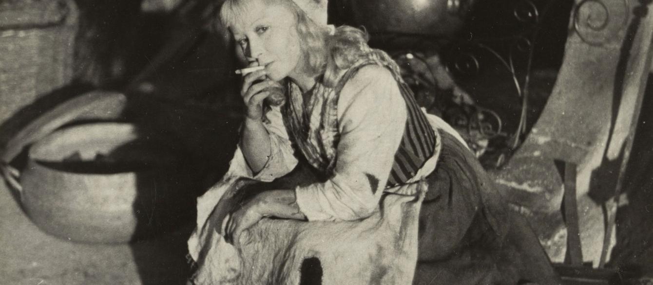 Actress Ianina Zheimo sits and smokes on the set of the movie "Cinderella.""