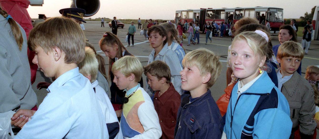 Soviet children out of the area of Chernobyl, Ukraina, line up at the gangway of the first ever West German plane that landed on East Berlins
