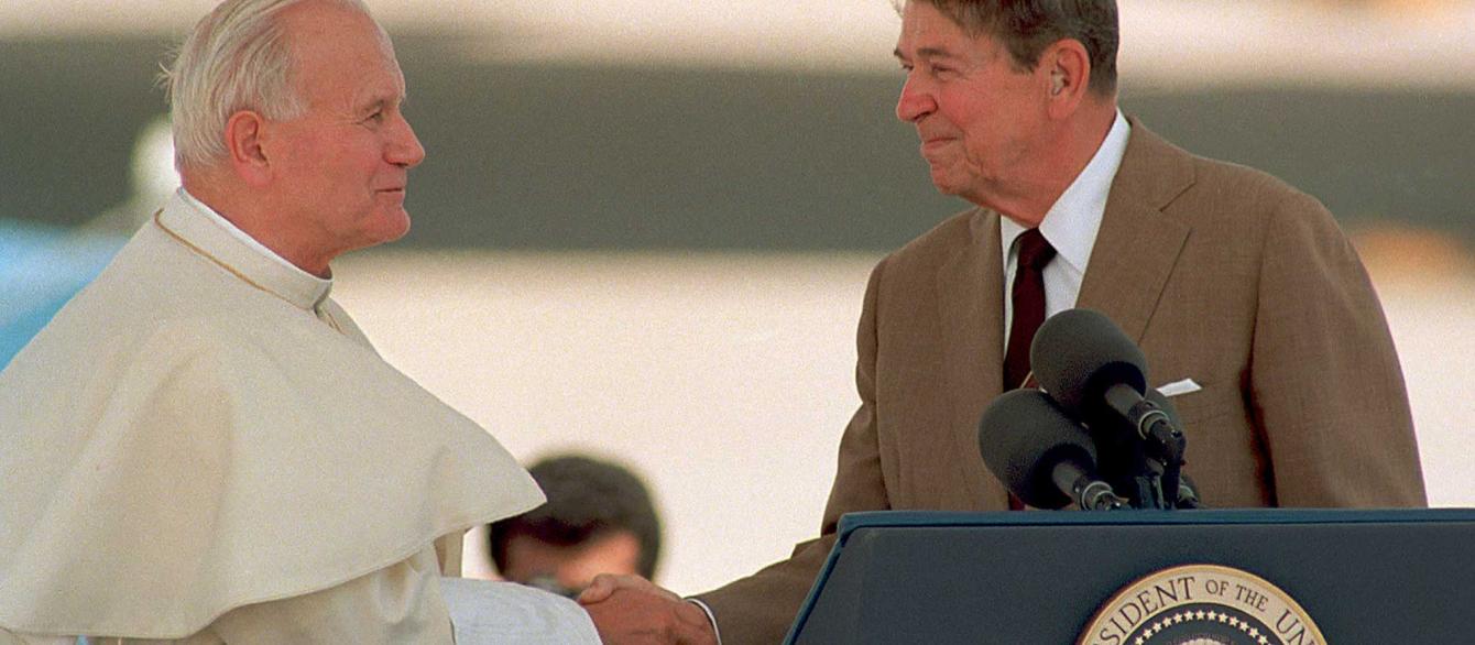 US President Ronald Reagan shakes hands with Pope John Paul II.