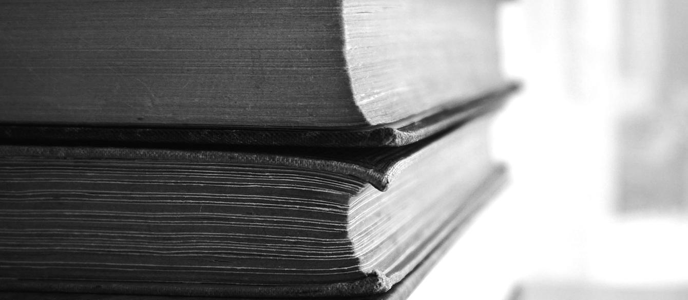 two book on top of each other black and white hotograph