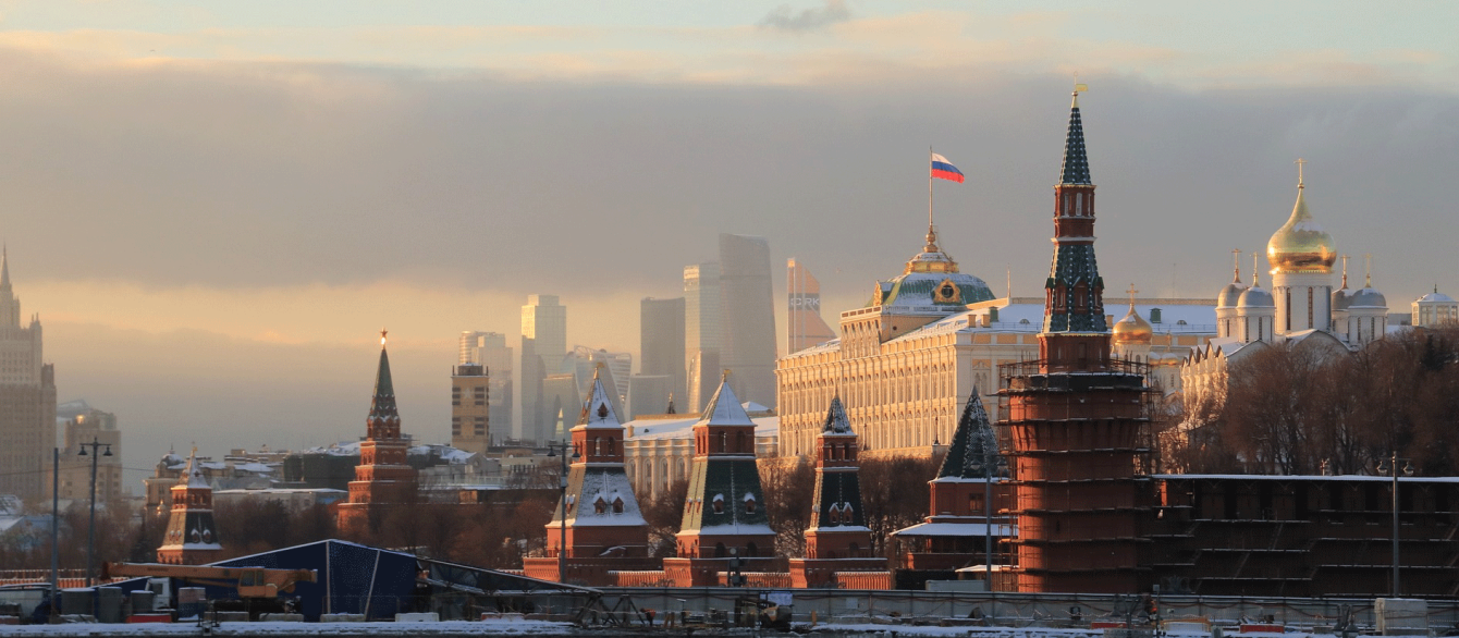 An Image of Moscow, Russia, featuring the Kremlin building at sunset.
