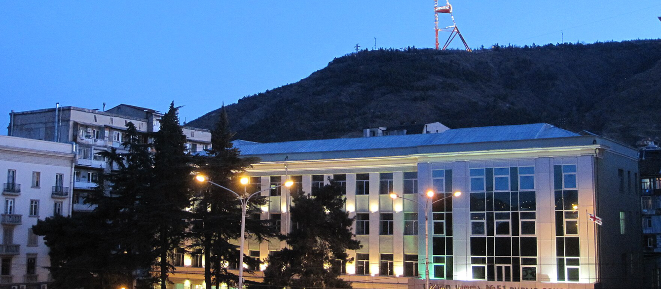 Tbilisi Public School #51 in Melikishvili Street with Mt. Mtatsminda and Tbilisi TV tower in the background. View from the Tbilisi Philharmonic Hall