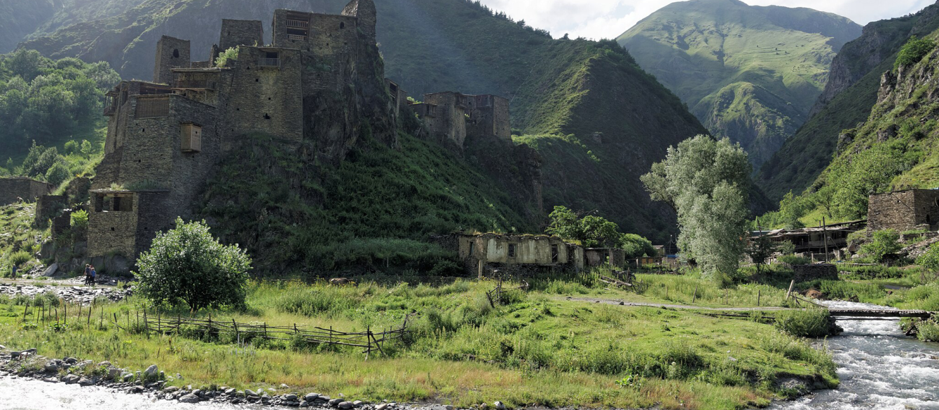 The Village-Fortress of Shaili in Georgia surrounded by green mountains and running water