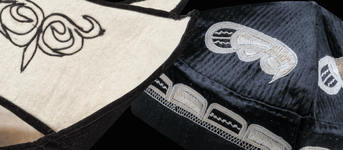 Two Central Asian hats with black background