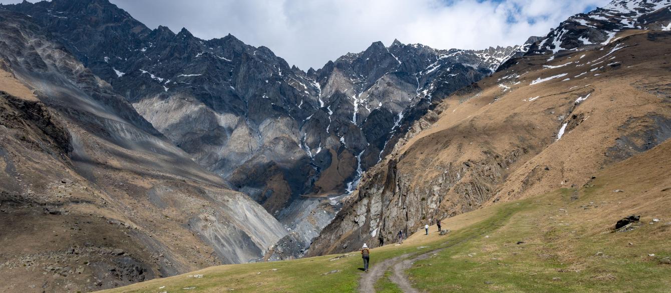 Hikers enjoy the spectacular view of the Greater Caucasus Mountains. Stepantsminda, the Republic of Georgia.