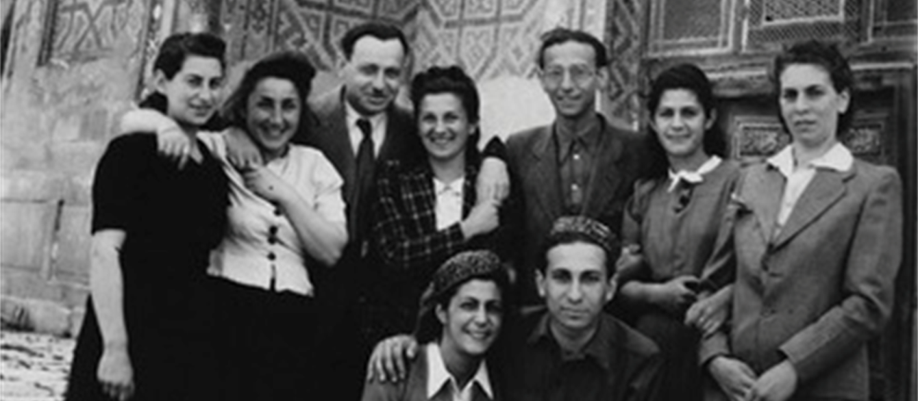 black and white photo of a group of people in front of Mosque