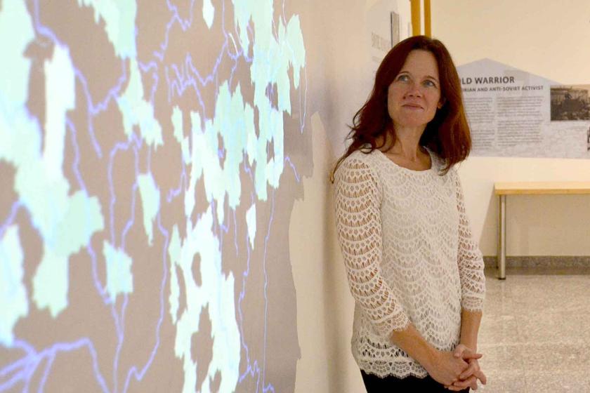 Kelly O'Neill in front of map projection