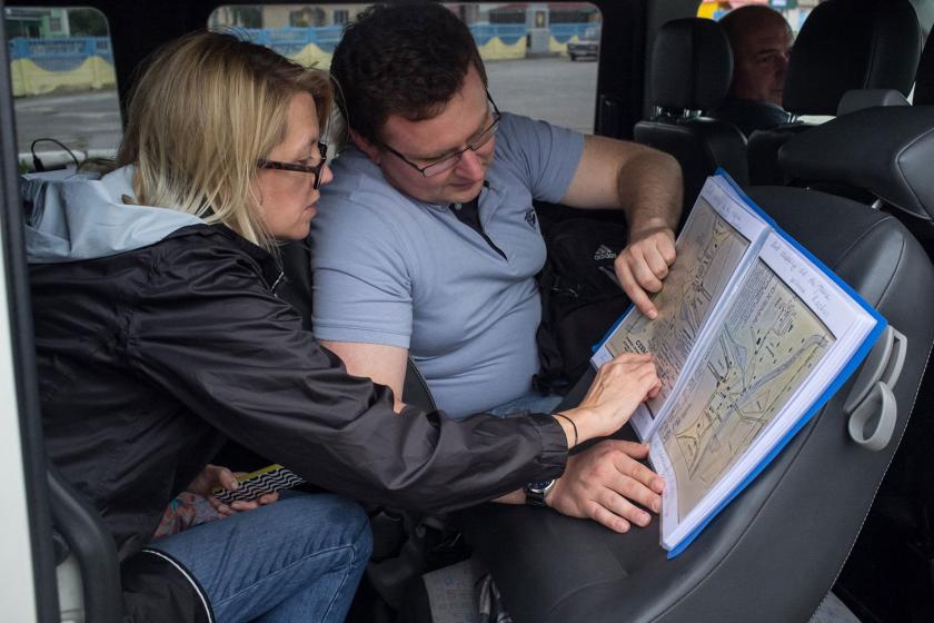 Wendy Lower and her fellow pointing at the map in the car