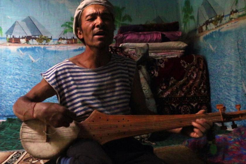 a man singing with mandolin
