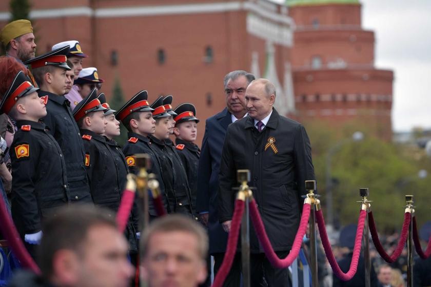 Putin walks past row of children in uniform at Victory Day parade on Red Square