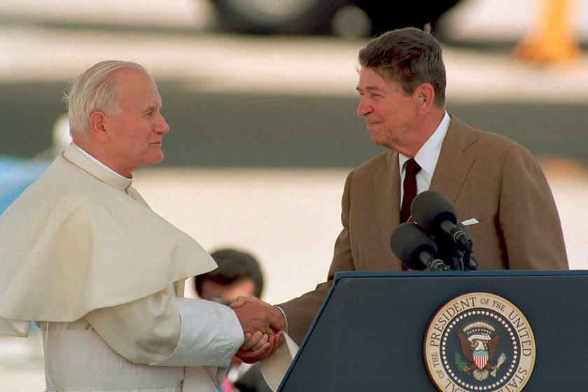 US President Ronald Reagan shakes hands with Pope John Paul II.
