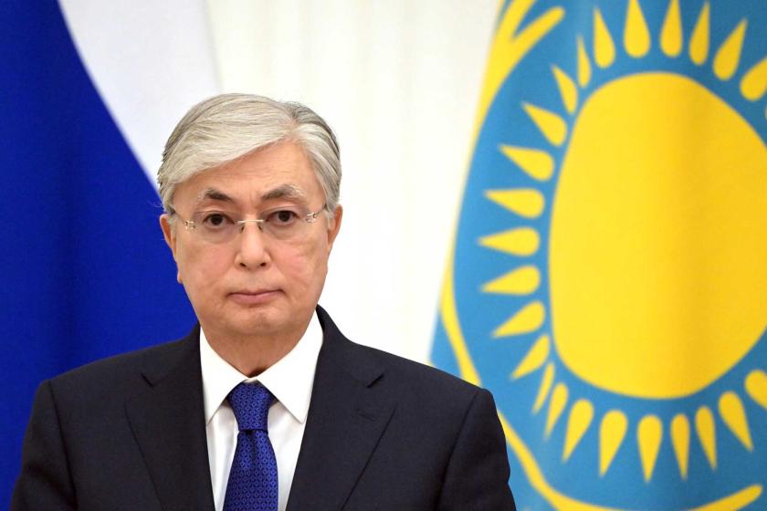 Kazakhstan's President Kassym-Jomart Tokayev with flags of Russia and Kazakhstan in background
