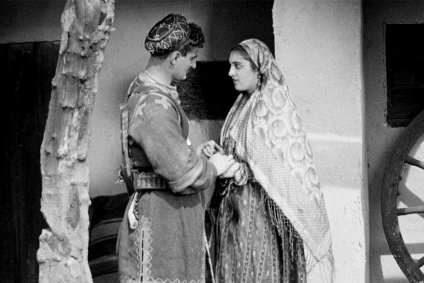 A couple holding hands in a still from the film Eliso
