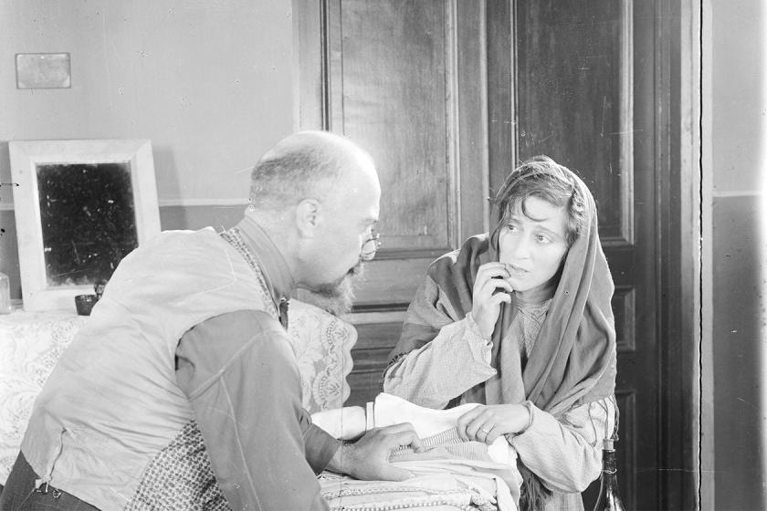 Two characters talk in the film Saba