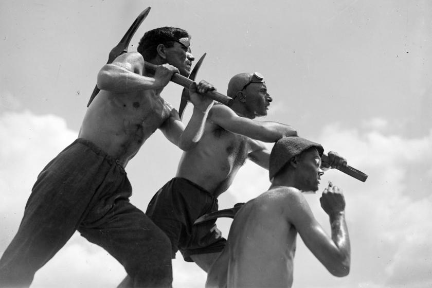 Three workers hold pick axes in a still from Salt for Svanetia