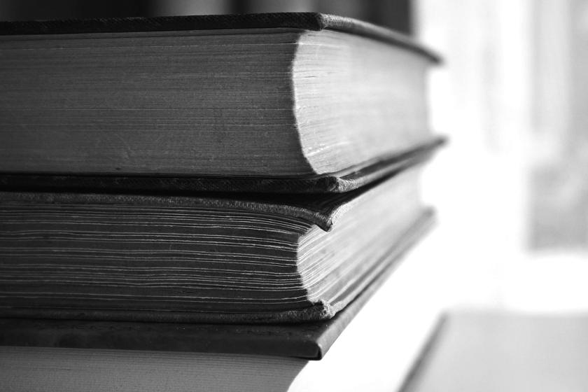 two book on top of each other black and white hotograph
