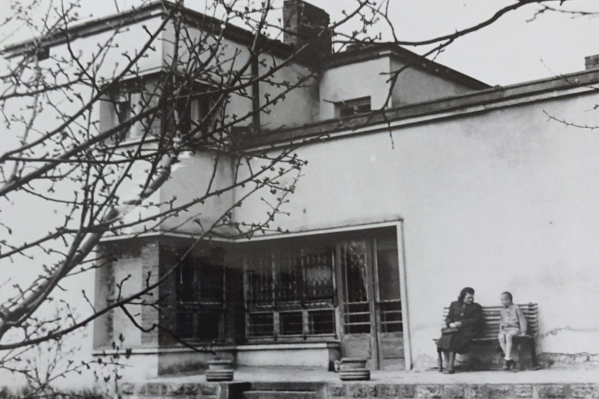 black and white photograph of the building and two women sitting on the bench