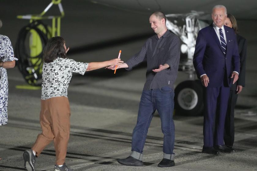 Reporter Evan Gershkovich is greeted on the tarmac by his mother, Ella Milman, as President Joe Biden and Kamala Harris look on at Andrews Air Force Base, Md., following his release as part of a 24-person prisoner swap between Russia and the United States, Thursday, Aug. 1, 2024. 