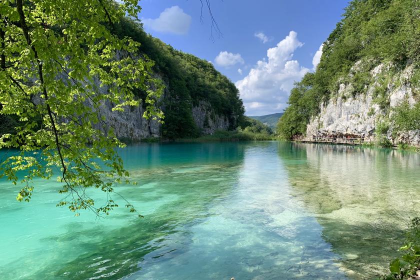 blue river between two mountains with trees