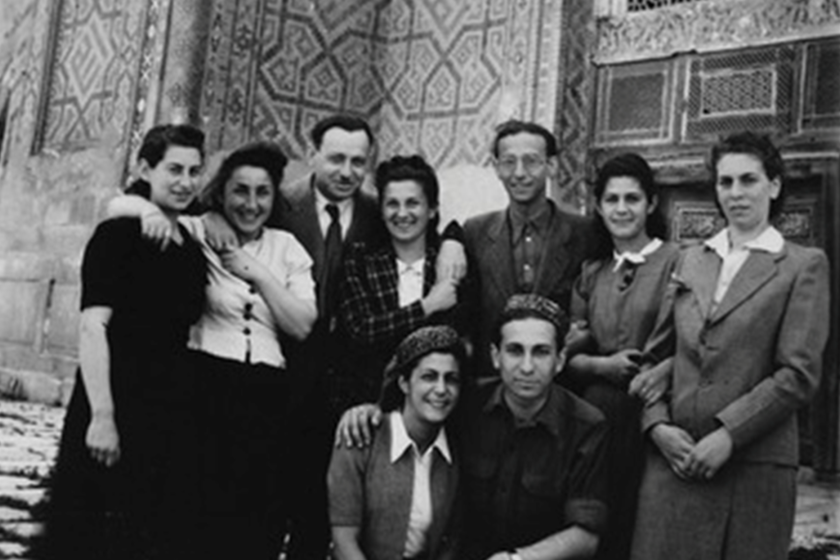 black and white photo of a group of people in front of Mosque