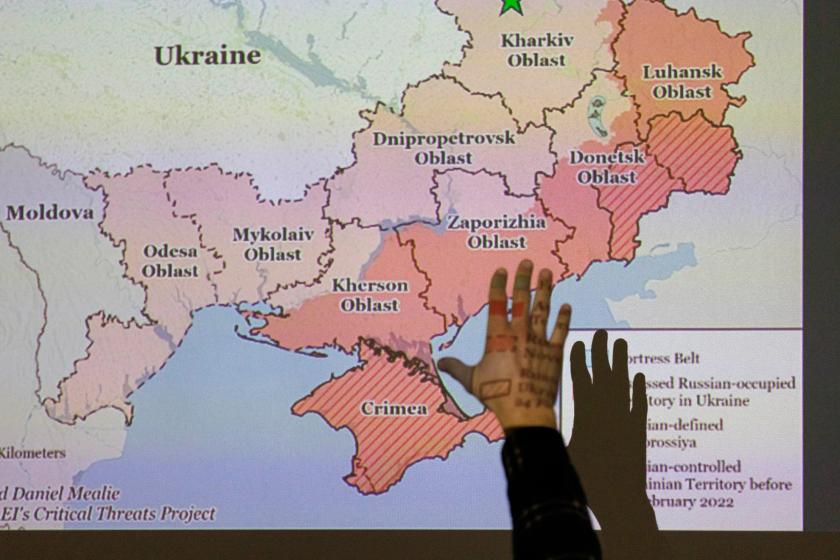 hand in front of a projected slide showing map of Ukraine