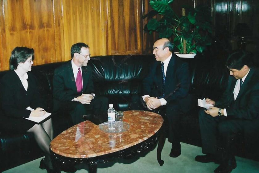 Four individuals sitting around a marble top table
