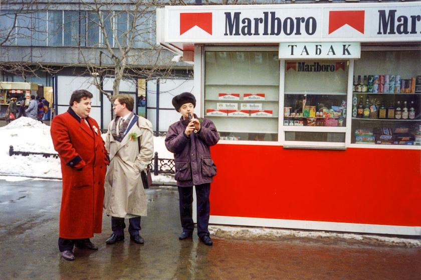 Group of men standing near a Marlboro kiosk