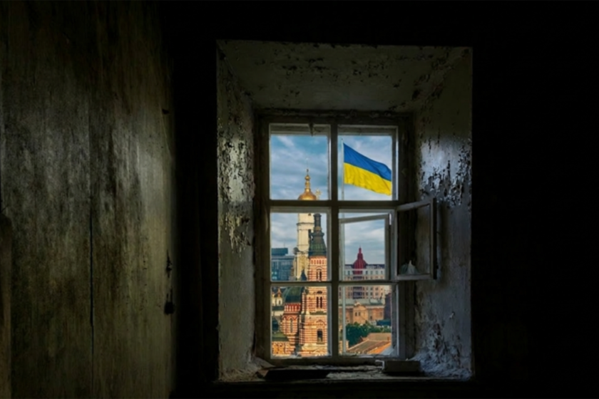 window looking out to the city with Ukraine flag