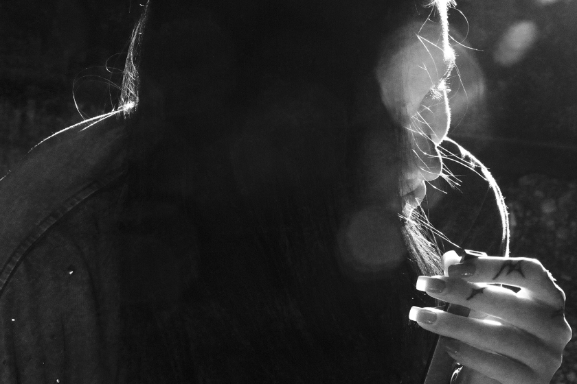 a women with hair coverd her face, black and white photo